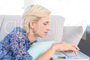 Pretty blonde woman doing online shopping