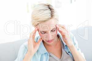 Blonde woman having headache