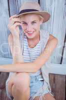 Pretty blonde woman wearing hat and smiling at camera
