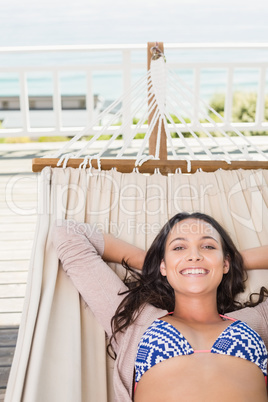 Pretty brunette relaxing on a hammock