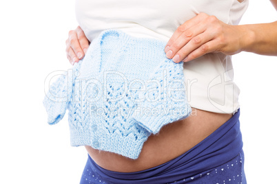 Pregnant woman holding baby clothes