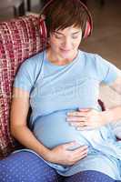Pregnant woman listening to music