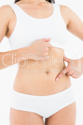 Fit woman touching her painful stomach