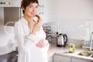 Pregnant woman eating a pickle