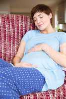 Pregnant woman relaxing on the couch