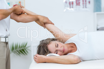Doctor stretching his patients arm