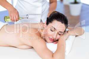 Smiling woman getting an aromatherapy treatment