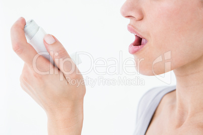 Asthmatic pretty brunette using inhaler