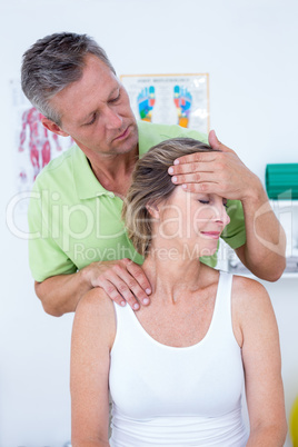 Doctor doing neck adjustment