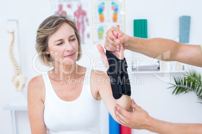 Doctor examining his patients wrist