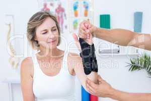 Doctor examining his patients wrist