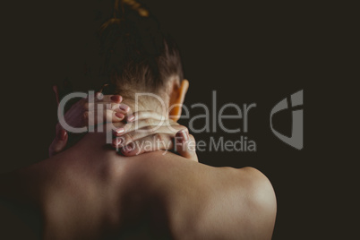 Nude woman with a neck injury