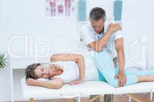 Doctor massaging his patient hip