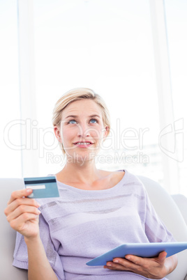 Pretty blonde woman doing online shopping