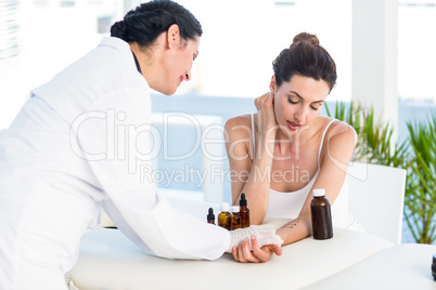 Doctor doing skin prick test at her patient