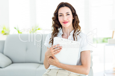 Smiling therapist holding her clipboard