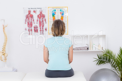 Woman sitting on massage table Woman sitting on massage table