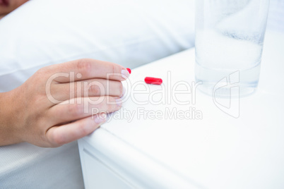 Woman taking pills before sleeping