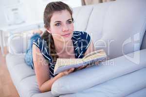 Thoughtful woman reading a book