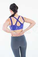 Fit woman suffering from back pain