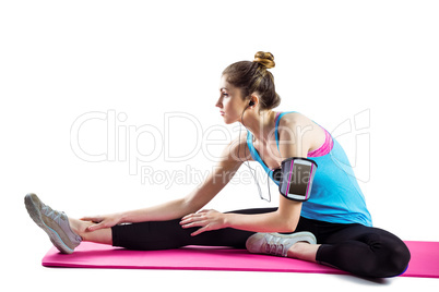 Fit woman stretching on exercise mat