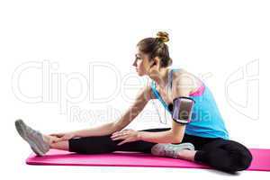 Fit woman stretching on exercise mat