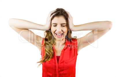 Pretty brunette shouting with hands on head Pretty brunette shouting with hands on head
