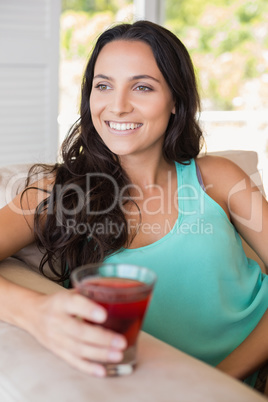 Pretty brunette sitting on the armchair