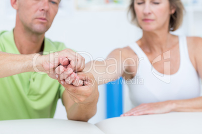 Doctor examining his patients hand