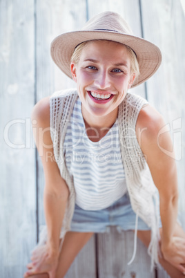 Pretty blonde woman wearing hat and smiling at camera