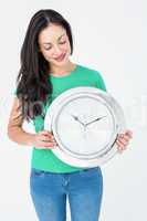 Brunette holding wall clock