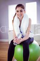 Fit woman with towel and water bottle