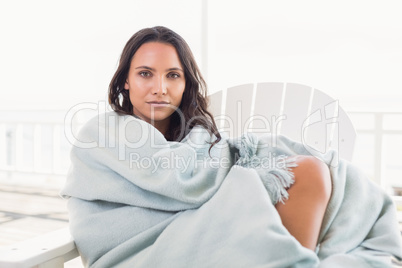 Pretty brunette sitting on a chair