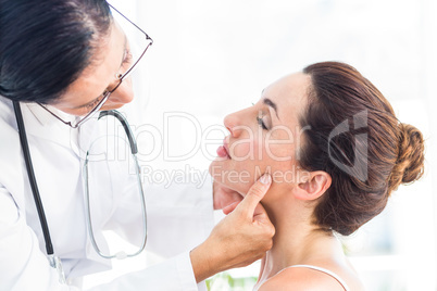 Doctor examining her patients jaw