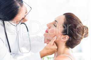 Doctor examining her patients jaw