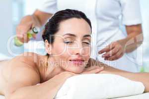 Smiling woman getting an aromatherapy treatment