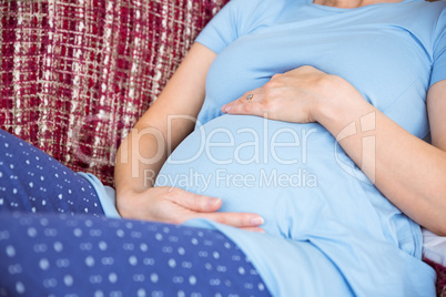 Pregnant woman relaxing on the couch