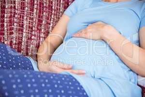 Pregnant woman relaxing on the couch