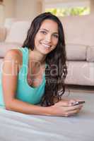 Pretty brunette texting with her smartphone