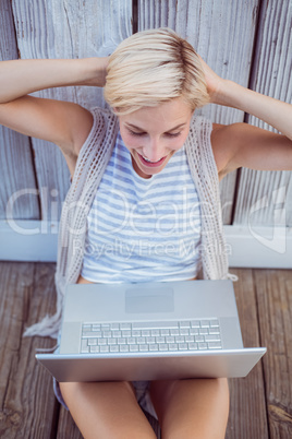 Pretty blonde woman using her laptop