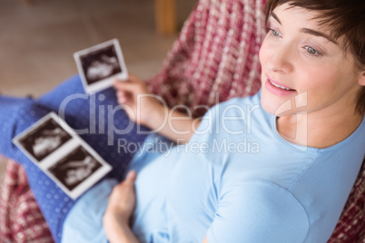 Pregnant woman looking at ultrasound scans