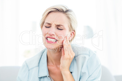 Blonde woman having toothache