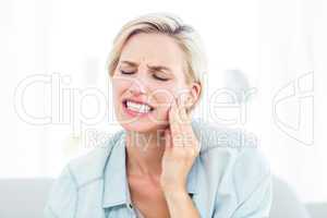 Blonde woman having toothache