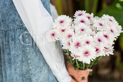 Pretty blonde woman holding bunch of flowers