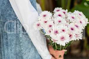 Pretty blonde woman holding bunch of flowers