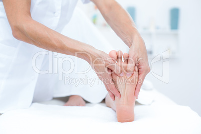 Physiotherapist doing foot massage