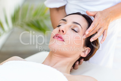 Brunette receiving head massage