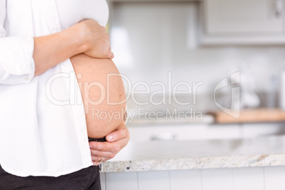 Pregnant woman holding her bump