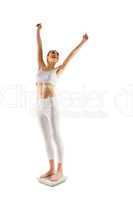 Slim woman cheering on scales