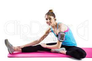 Fit woman stretching on exercise mat